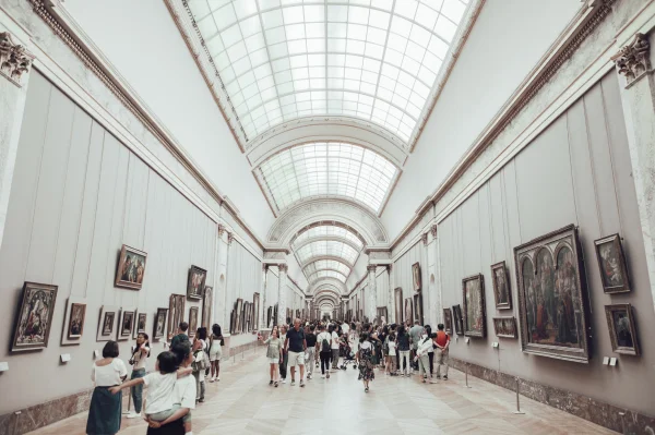 people walking through the louvre galleries